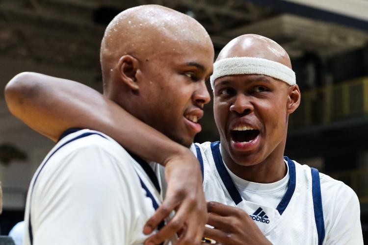 Twin men's basketball players on the court